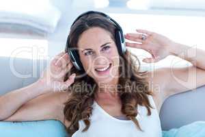 Portrait of happy woman listening to music