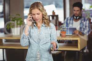 Beautiful businesswoman talking over phone in office
