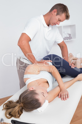 Doctor stretching a young woman back