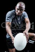 Determined rugby player with ball