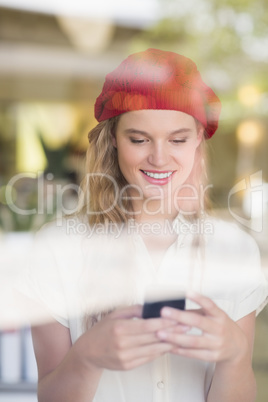 Happy woman using her phone