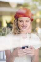 Happy woman using her phone