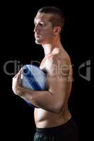 Sexy shirtless sports player holding ball