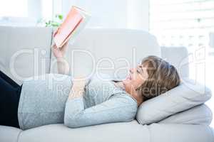 Happy woman reading book at home