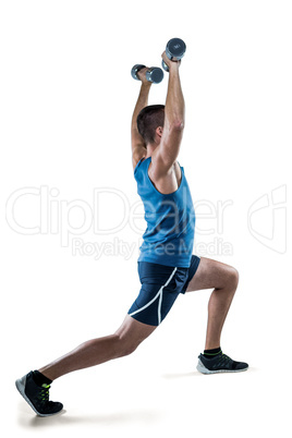 Man in sportswear exercising with dumbbells