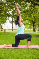 Young woman doing yoga on mat