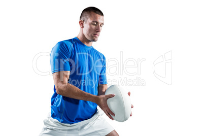 Rugby player in blue jersey holding ball