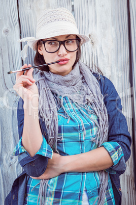 Happy hipster holding a paintbrush