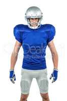 Serious American football player standing