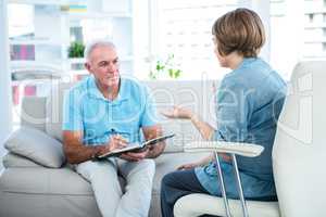 Doctor discussing with patient at home
