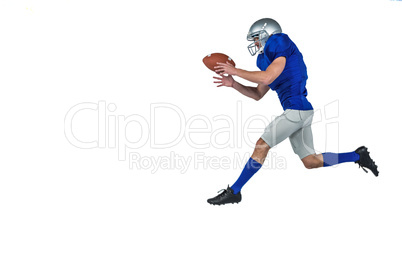 American football player running while catching ball