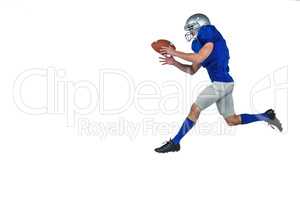 American football player running while catching ball