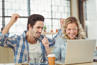 Colleagues cheering in office Colleagues cheering in office