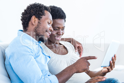 Husband pointing towards digital tablet