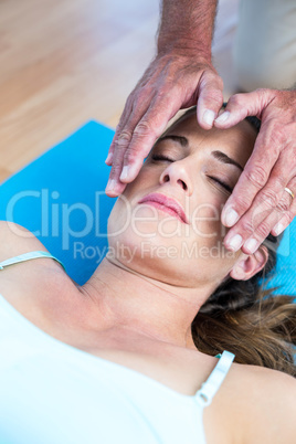 High angle view of relaxed woman getting reiki treatment