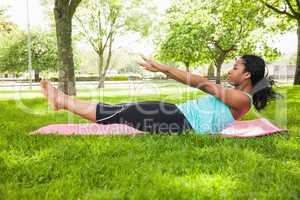 Young woman doing pilates on mat