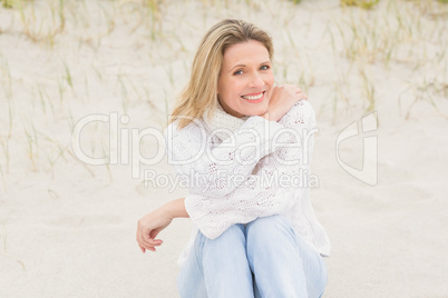 Woman sitting near the sandy hill