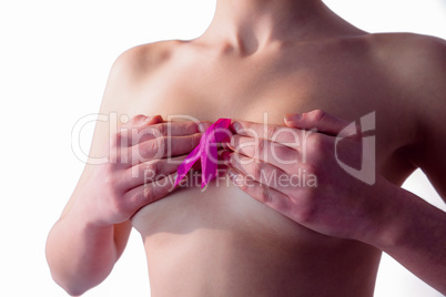 Nude woman with breast cancer ribbon