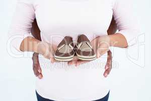 Midsection of woman carrying shoes with man