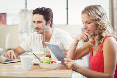 Businesswoman looking at digital tablet in office