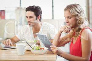 Businesswoman looking at digital tablet in office