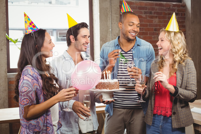 Casual business people celebrating birthday in office