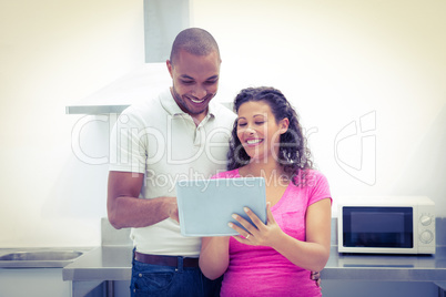 Happy couple using digital laptop