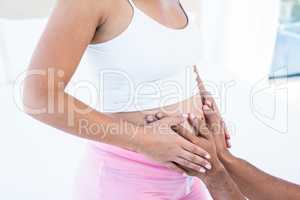 Pregnant wife with husband touching belly