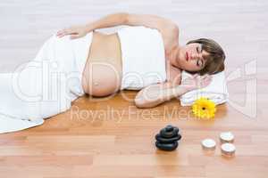 Pregnant woman with eyes closed relaxing