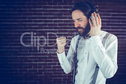 Serious hipster with eyes closed enjoying music