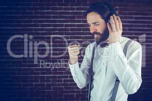 Serious hipster with eyes closed enjoying music