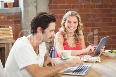 Portrait of happy businesswoman holding tablet in office