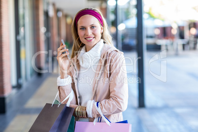 Smiling woman holding smartphone