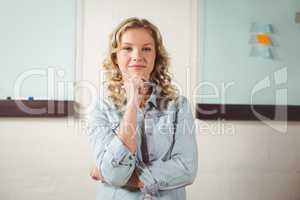 Portrait of beautiful confident woman standing in office