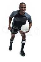 Rugby player with ball standing in position