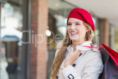 A smiling woman with shopping bags