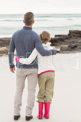 Father and daughter looking at the sea