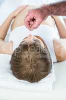 Therapist performing reiki over pregnant woman