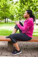 Fit woman sitting on bench