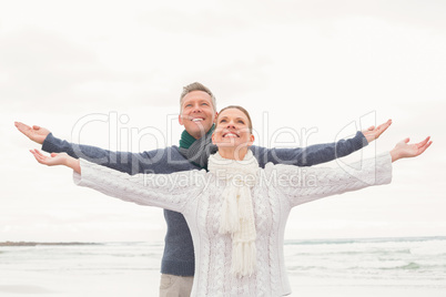 Cute couple standing with arms open wide