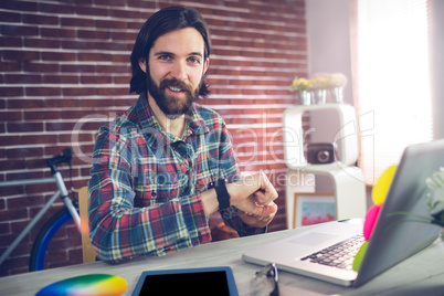 Portrait of smiling businessman checking time