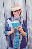 Happy hipster reading a book