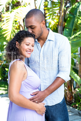 Husband kissing pregnant wife head