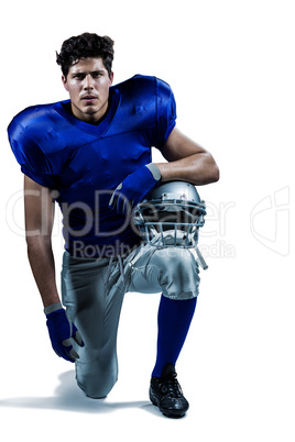 Portrait of serious sportsman holding helmet