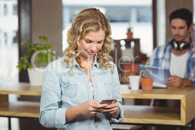 Businesswoman using smartphone in office