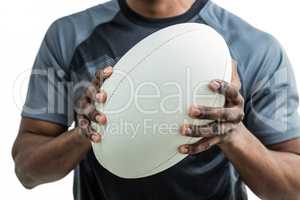 Mid section of sportsman holding rugby ball