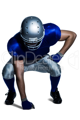 American football player in uniform bending