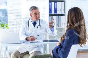 Male doctor advising pregenat woman in clinic