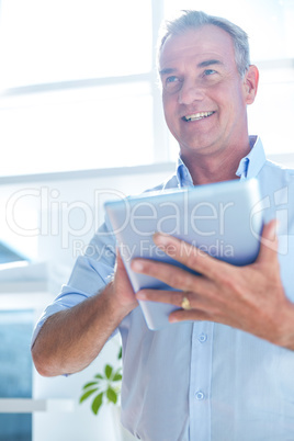 Businessman holding digital tablet at office