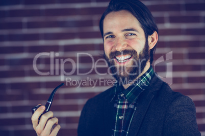 Portrait of happy man smoking pipe